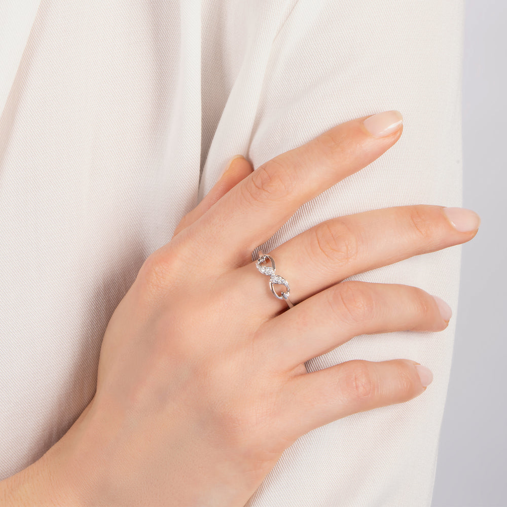 Hallmark Fine Jewelry Contemporary Infinity Ring in Sterling Silver with 1/10 Cttw of Diamonds